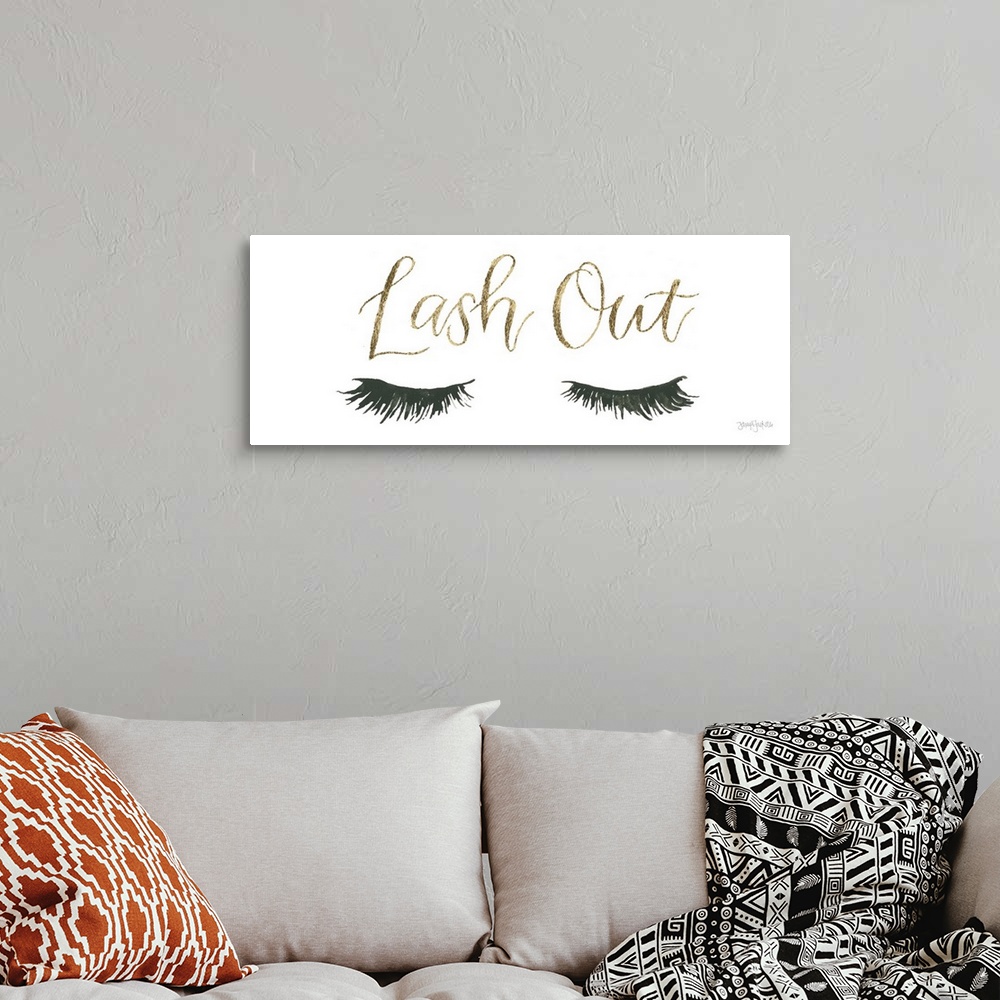 A bohemian room featuring Decorative artwork of a pair of feminine eyelashes and the text "Lash Out" in gold.