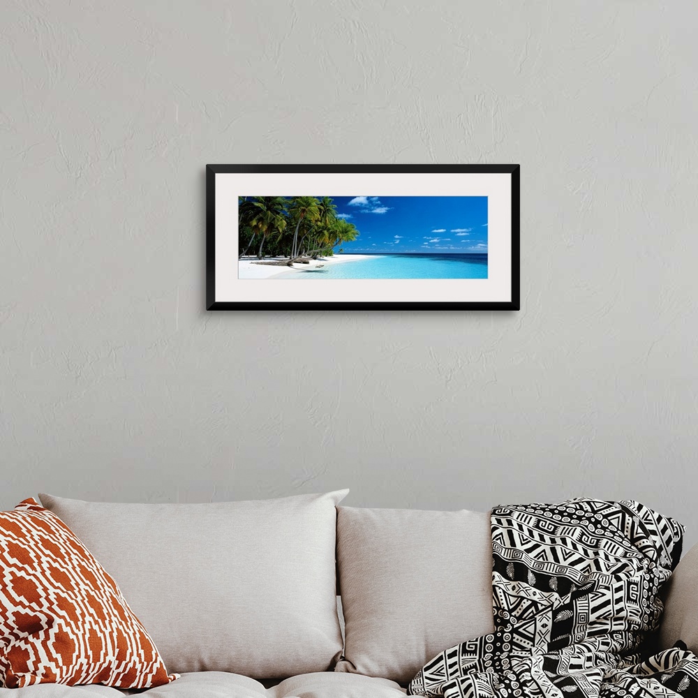 A bohemian room featuring Panoramic photograph of a vibrant beach on a sunny day in Maldives.  The tall palm trees run acro...