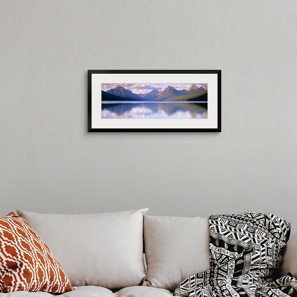 A bohemian room featuring Oversized, horizontal photograph of mountains reflecting in the calm waters of Lake McDonald in G...