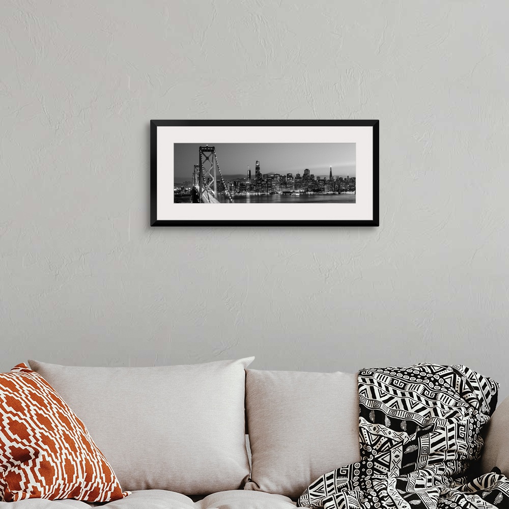 A bohemian room featuring Photograph of the Bay Bridge and the San Francisco skyline lit up at dusk.
