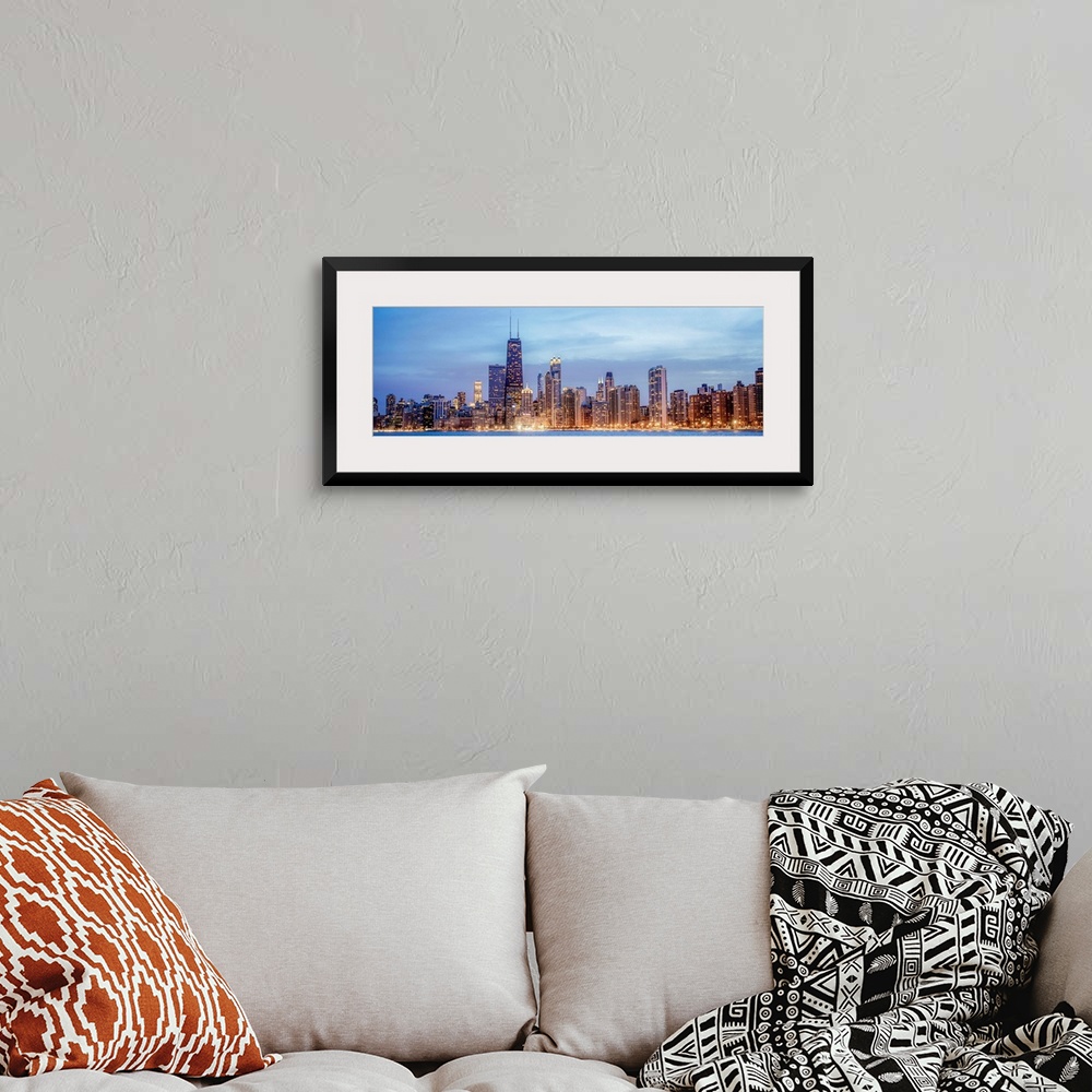 A bohemian room featuring Panoramic view of the Chicago city skyline illuminated in the early evening, seen from the edge o...
