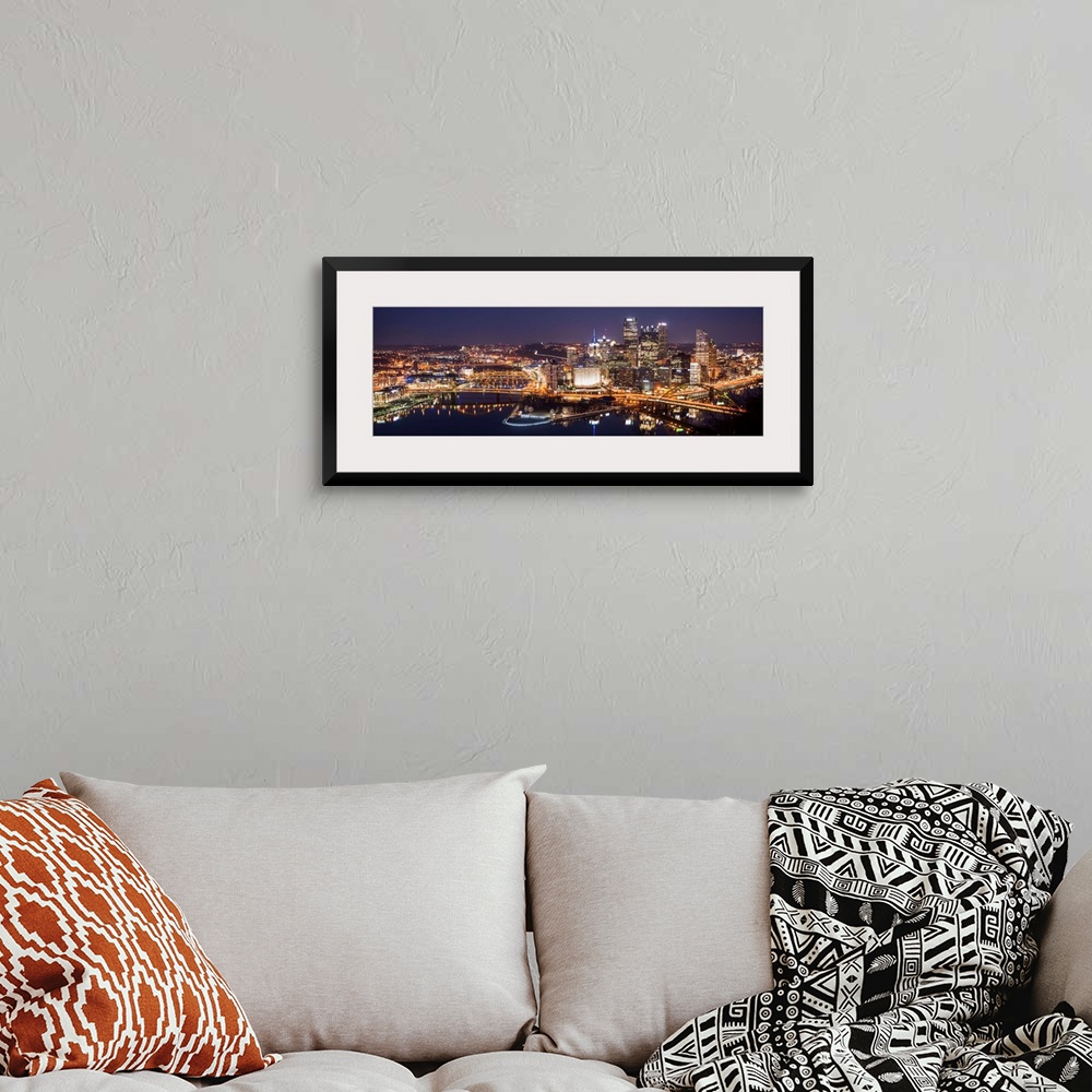 A bohemian room featuring Panoramic photo of the city of Pittsburgh illuminated at night, with Point State Park in the fore...