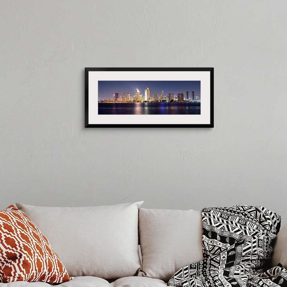 A bohemian room featuring Panoramic photograph of the San Diego, California skyline lit up at night from across the water.