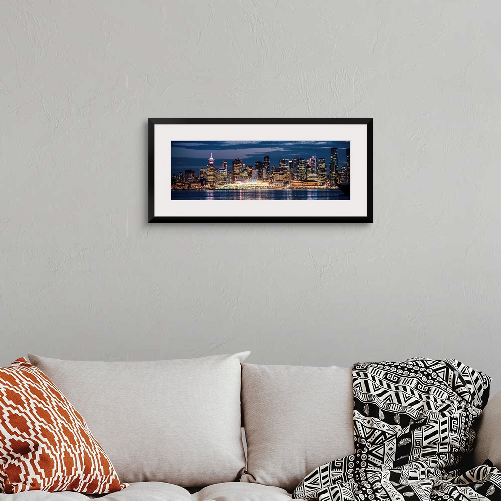 A bohemian room featuring Panoramic photograph of the Vancouver, British Columbia skyline lit up on a dark blue night and r...