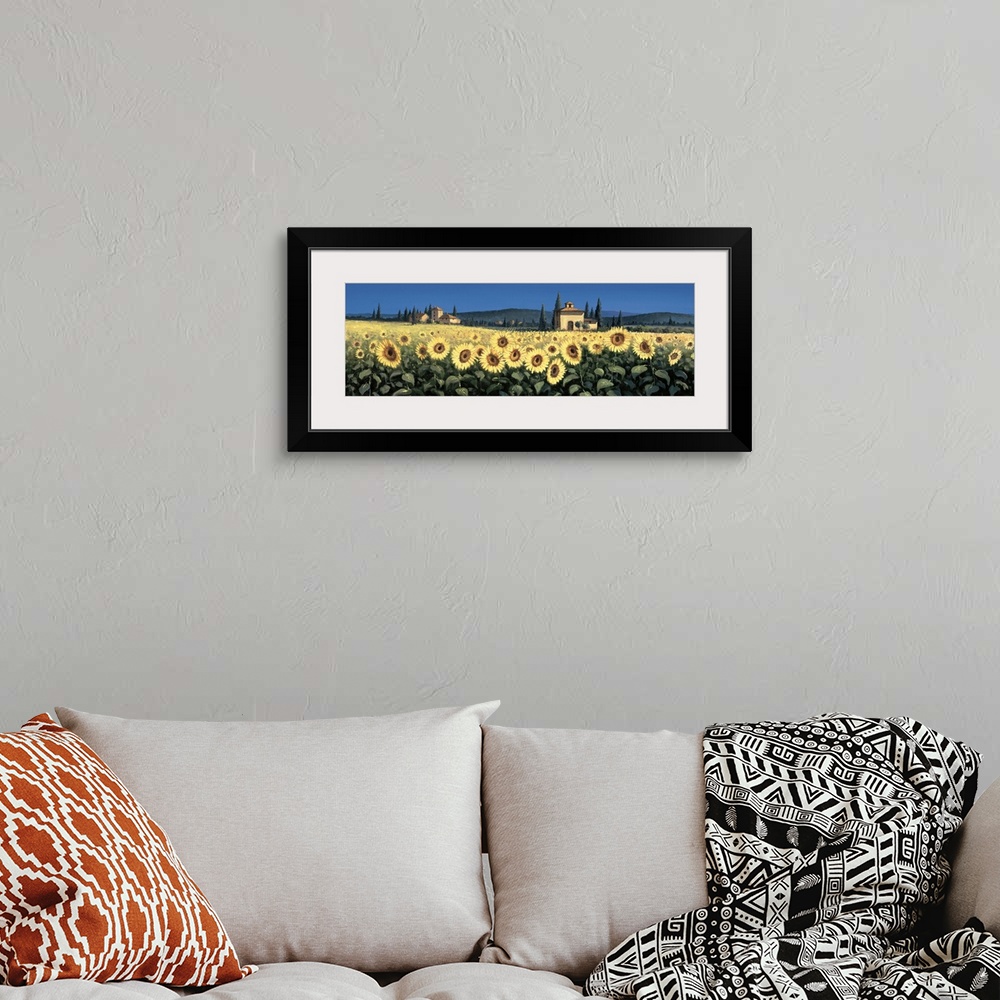 A bohemian room featuring Contemporary artwork of a field of sunflowers in Tuscany.