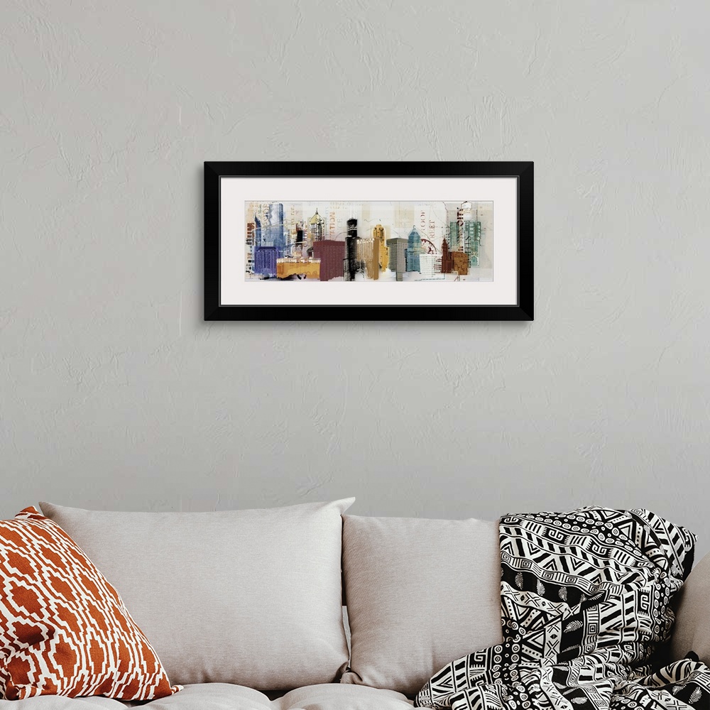 A bohemian room featuring A panoramic painting of multi-colored skyscrapers with words overlapping.