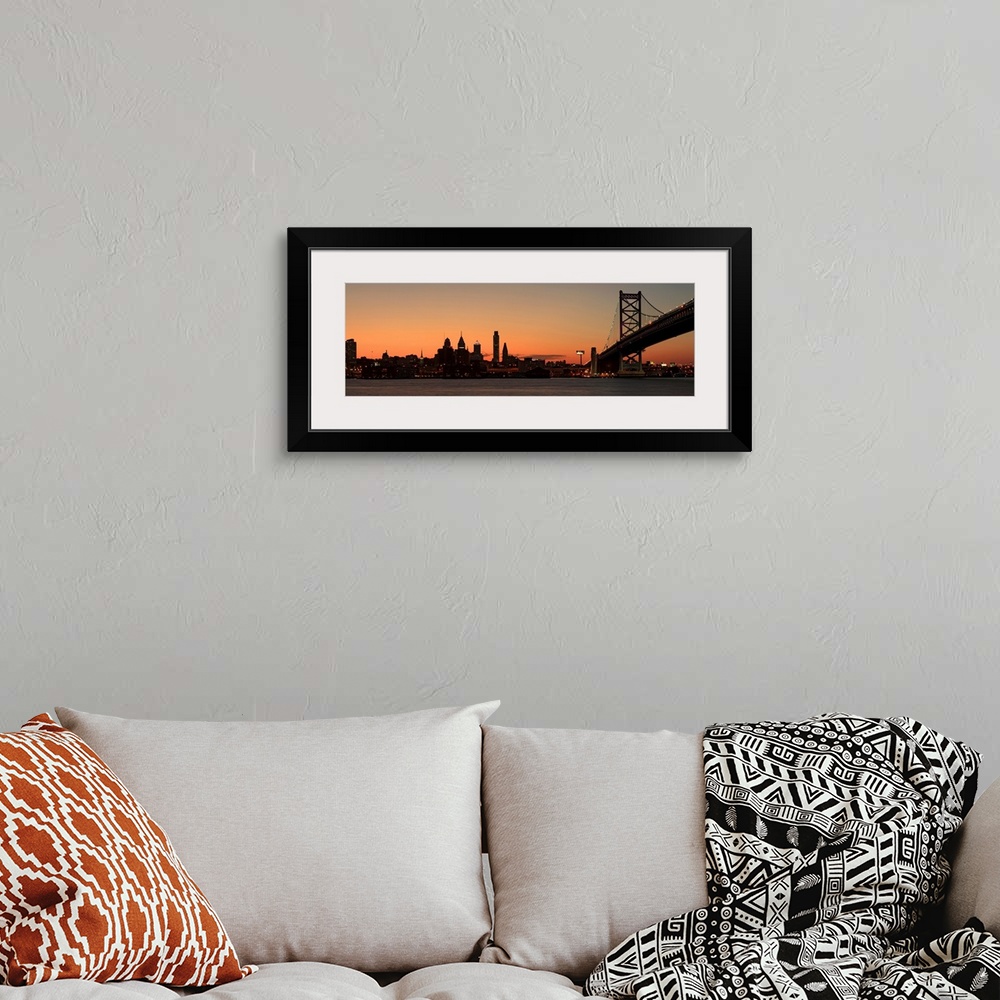 A bohemian room featuring Long horizontal image of the silohuette of the skyline of Philadelphia along the water front with...