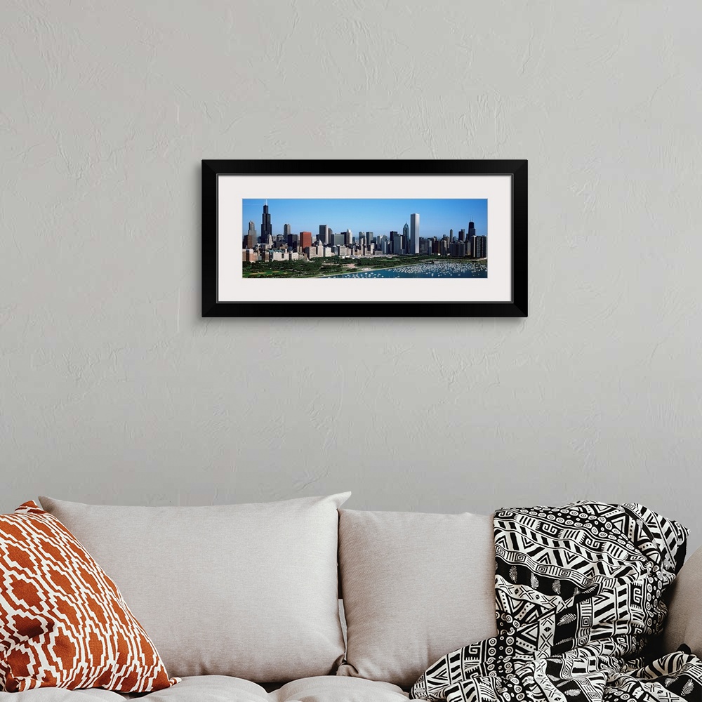 A bohemian room featuring This panoramic photograph shows the city skyline and a crowded harbor on the lake on a sunny clou...