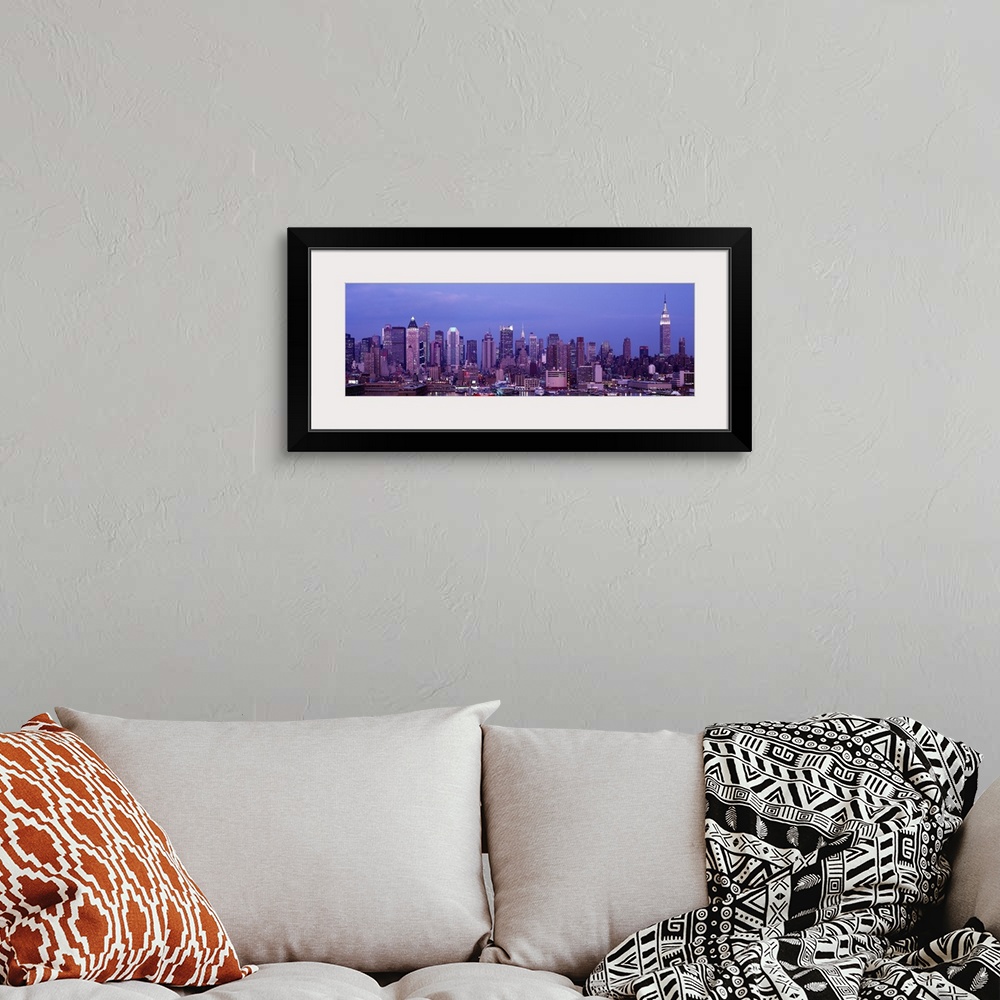 A bohemian room featuring This panoramic photograph was taken at dusk of the Manhattan skyline from across the water.