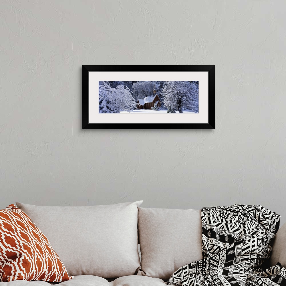 A bohemian room featuring Panoramic photo of a church in winter covered in snow at Yosemite National Park in California.