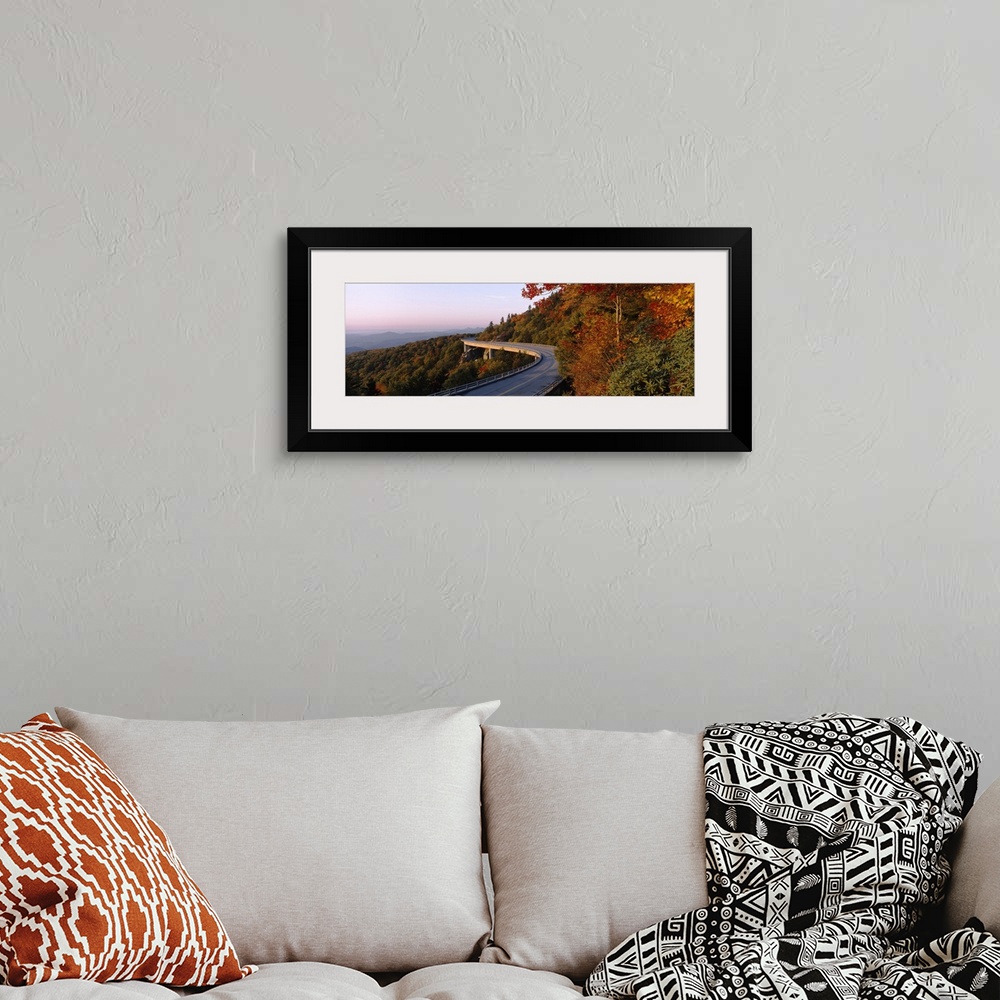 A bohemian room featuring Panoramic photograph of winding mountain road with tree tops below it and mountain silhouette in ...