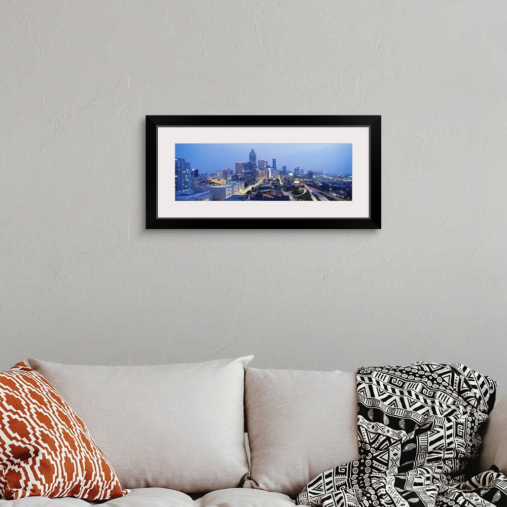 A bohemian room featuring An aerial photograph taken of downtown Atlanta with the buildings illuminated and the streets lit...