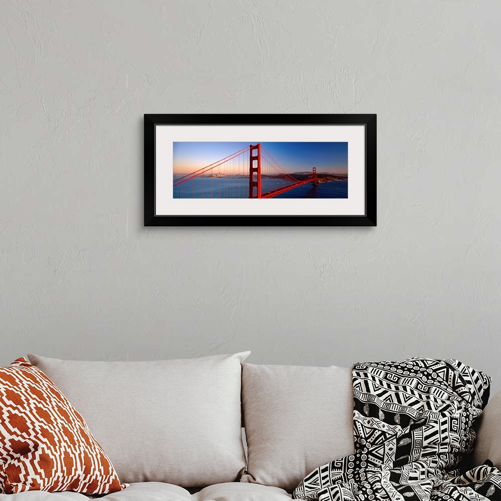 A bohemian room featuring Big landscape photograph of the Golden Gate Bridge extending over the blue waters of the San Fran...