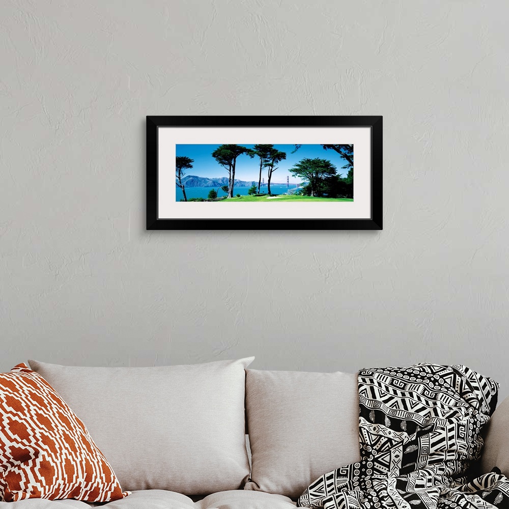 A bohemian room featuring Big panoramic photograph of a seaside golf course in San Francisco, California (CA) with mountain...