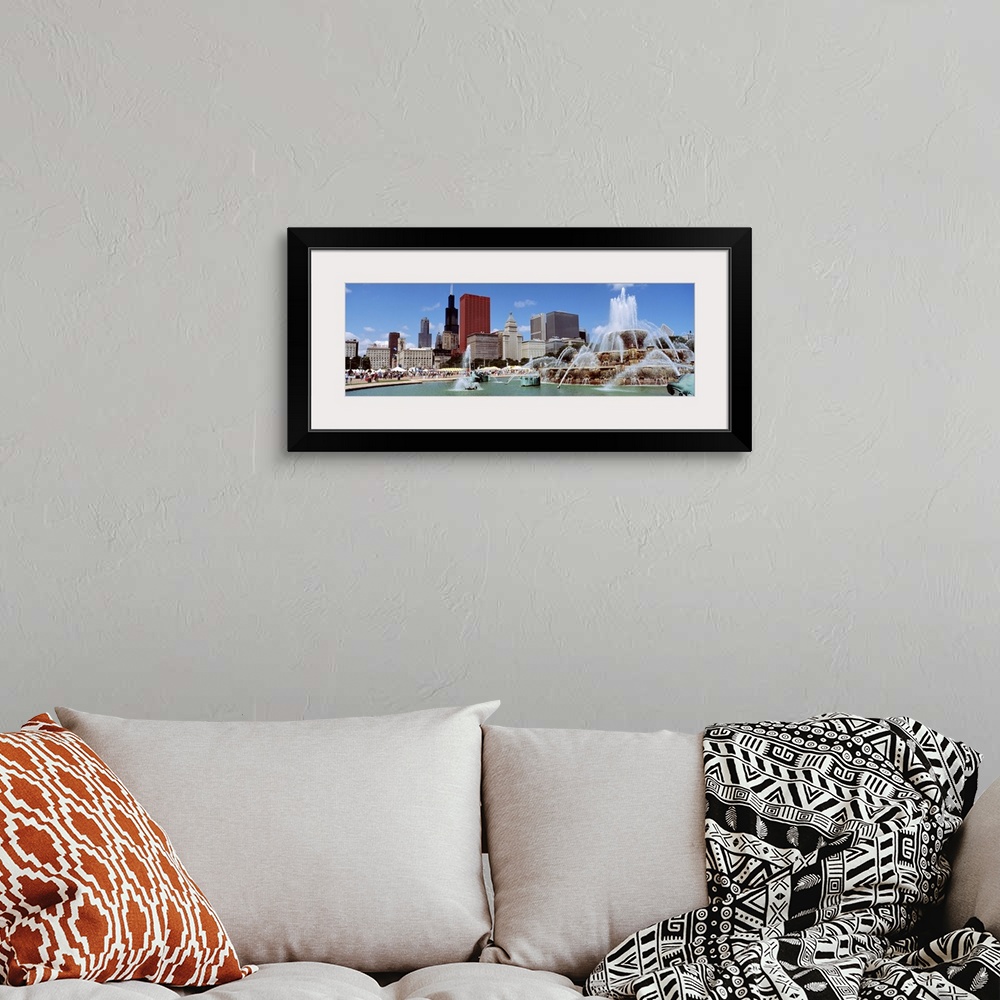 A bohemian room featuring Panoramic view of the Buckingham Fountain in the center of the busy city on a warm, sunny day.