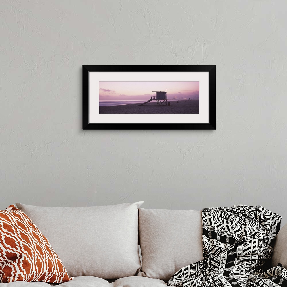 A bohemian room featuring Long horizontal photo print of a lifeguard station on the beach along the Pacific ocean with the ...