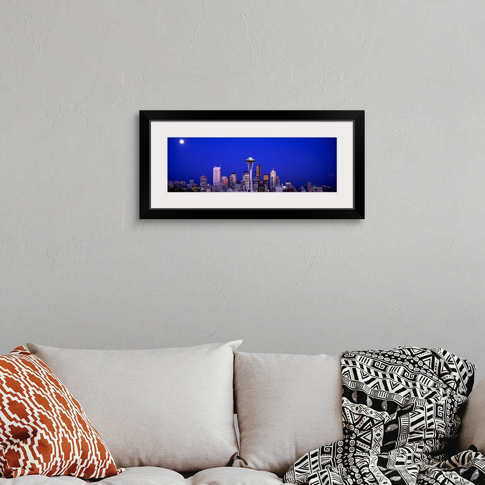 A bohemian room featuring The city skyline illuminated in the moonlight.