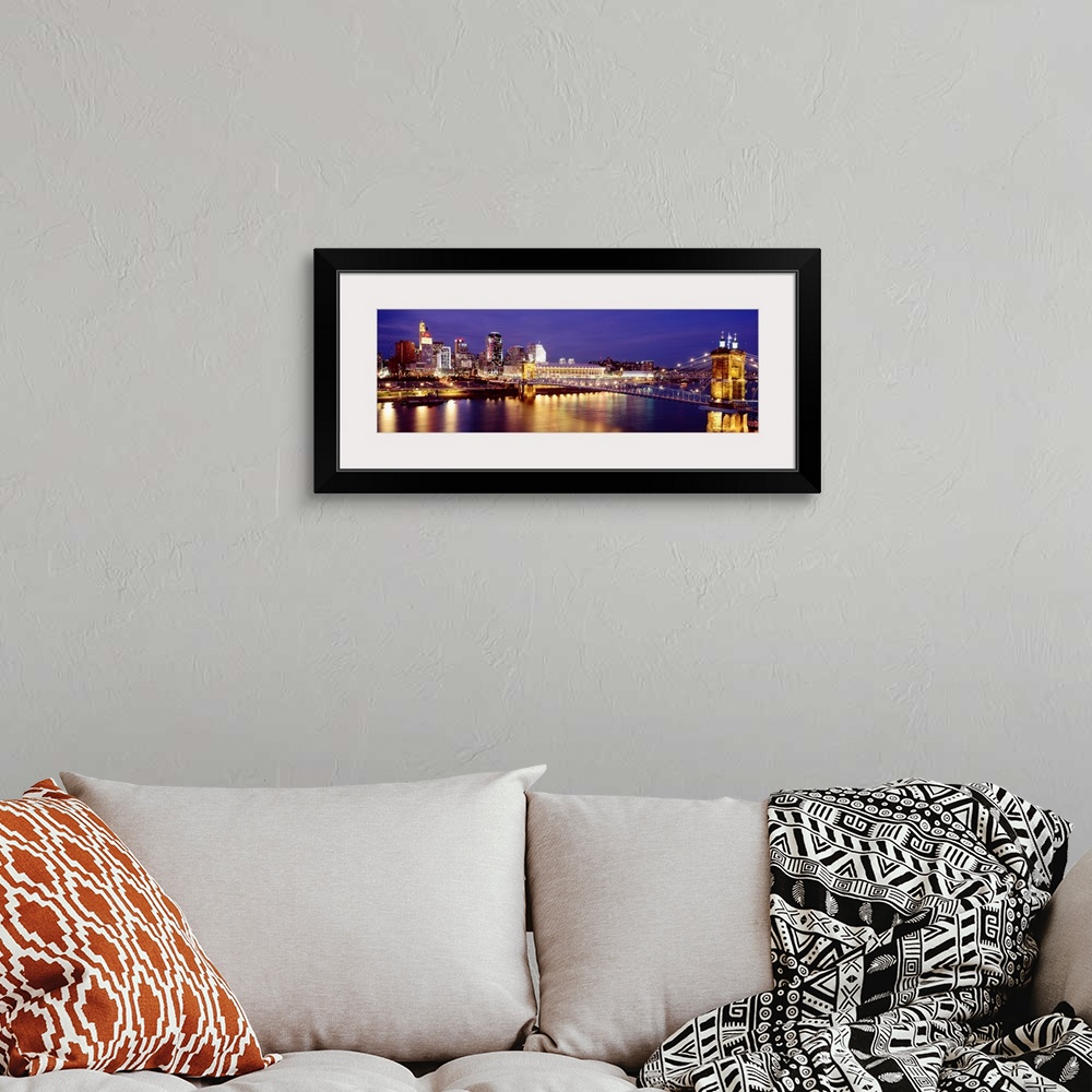A bohemian room featuring Horizontal photograph on a large canvas of the night lights of Cincinnati's downtown waterfront a...