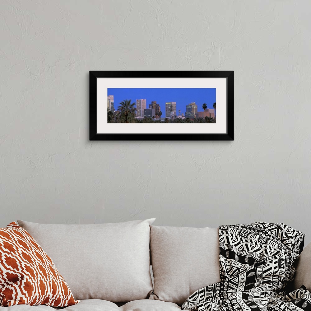 A bohemian room featuring Phoenix, Arizona palm trees and cityscape in a panoramic view.