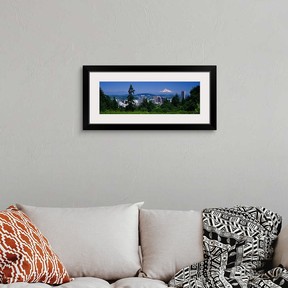 A bohemian room featuring Landscape, panoramic photograph looking down at the Portland skyline from a tree lined hillside.