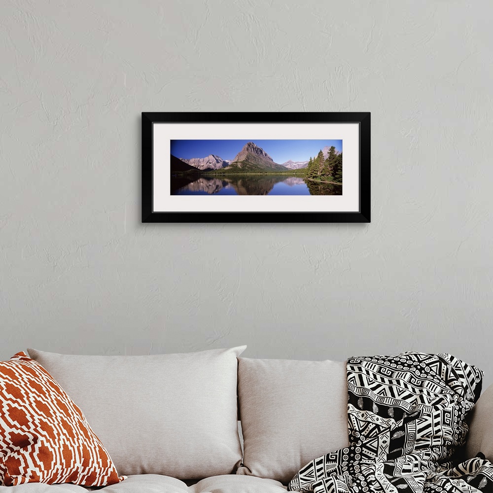 A bohemian room featuring Reflection of mountains in a lake, Swiftcurrent Lake, Many Glacier, US Glacier National Park, Mon...