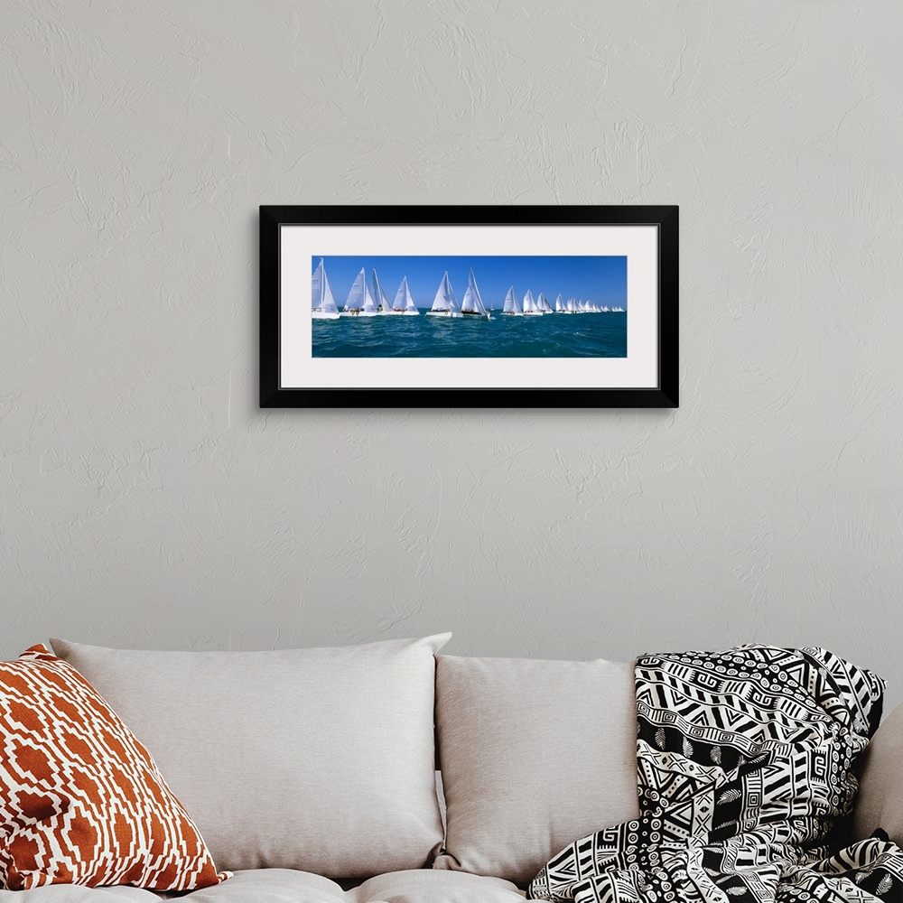A bohemian room featuring Long and narrow photo print of sailboats lined up in the ocean for a race.
