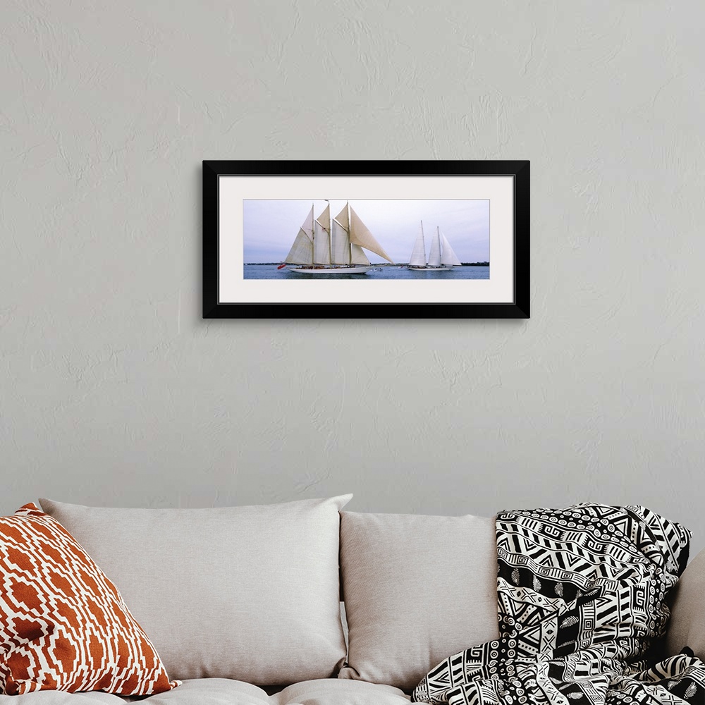 A bohemian room featuring Panoramic canvas photo of two big sailboats in a bay.