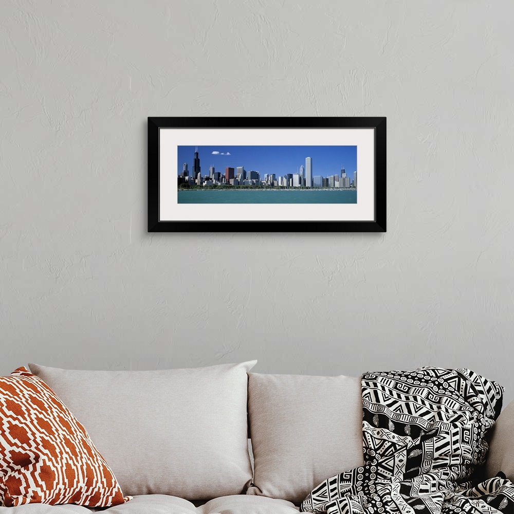 A bohemian room featuring Panoramic photograph shows a row of skyscrapers in the Midwestern United States overlooking the c...