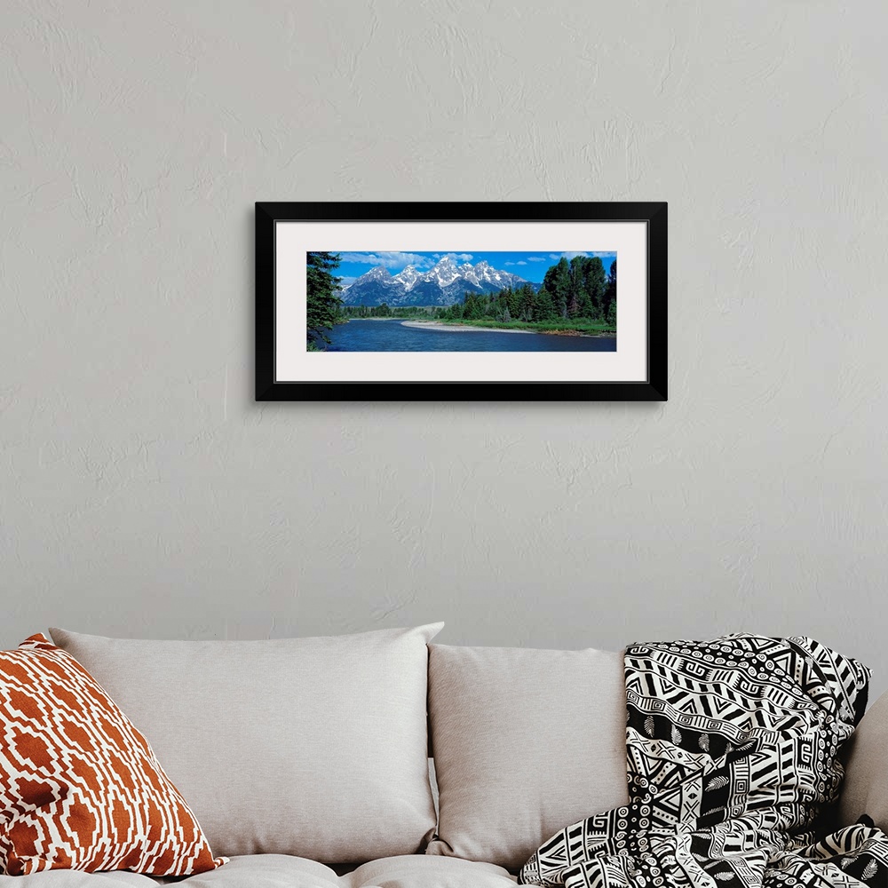 A bohemian room featuring Panoramic photo of rugged mountains in the background of a wide river cutting through the landsca...