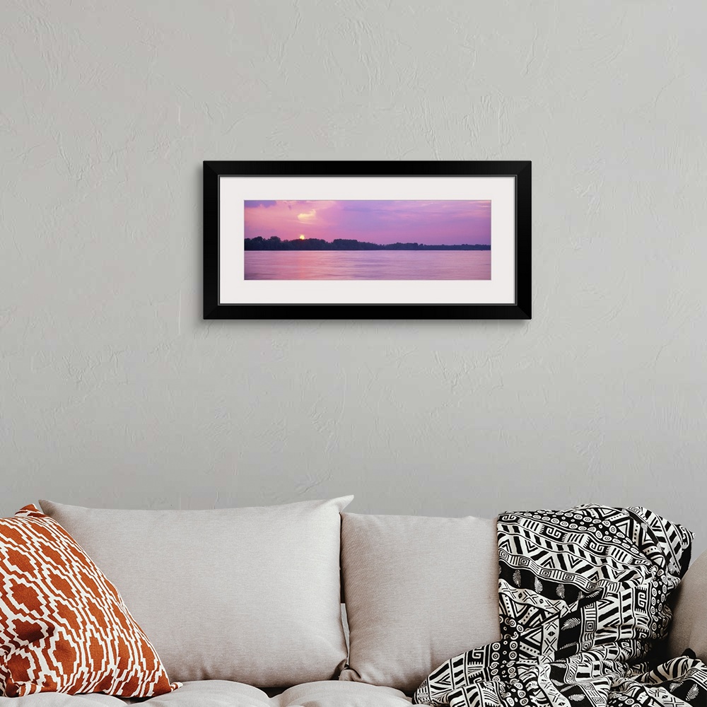 A bohemian room featuring A pink-hued sunset panorama of the Mississippi riverbanks in Memphis, Tennessee.