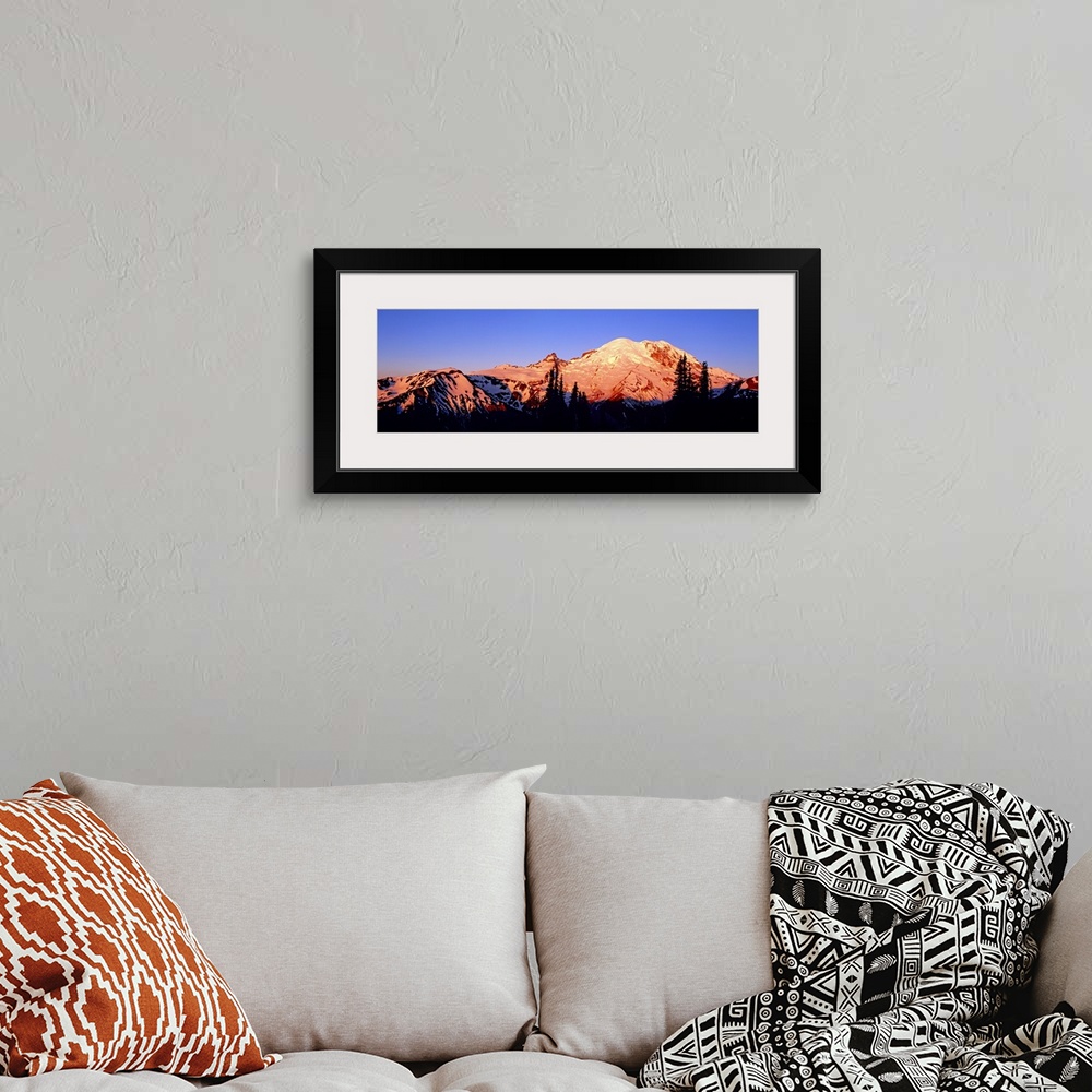 A bohemian room featuring Panoramic photograph taken of snow topped mountains during sunset with the trees in front silhoue...