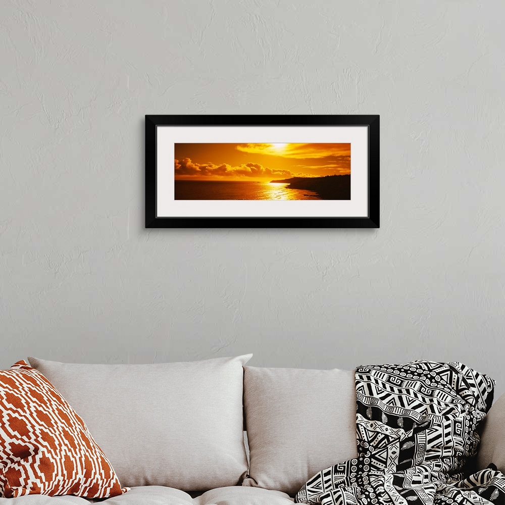 A bohemian room featuring This photograph is a panoramic seascape of the sun reflecting off the shallow beach water as it s...