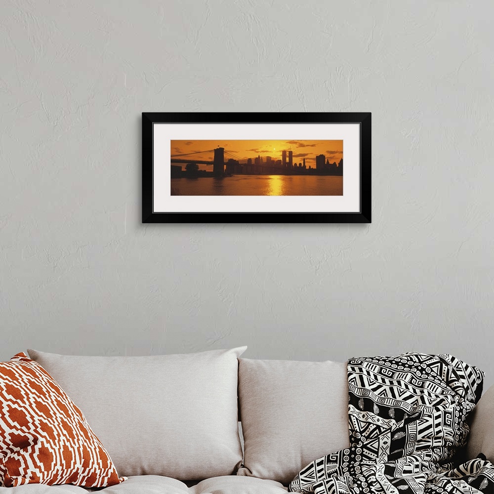 A bohemian room featuring This wall art for the home or office is a panoramic photograph of the Manhattan skyline silhouett...