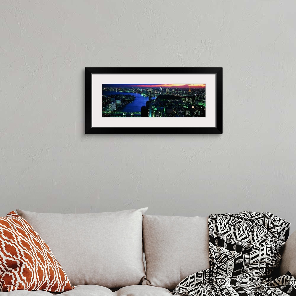 A bohemian room featuring Panoramic photo on canvas of a lit up downtown cityscape with water flowing through it.