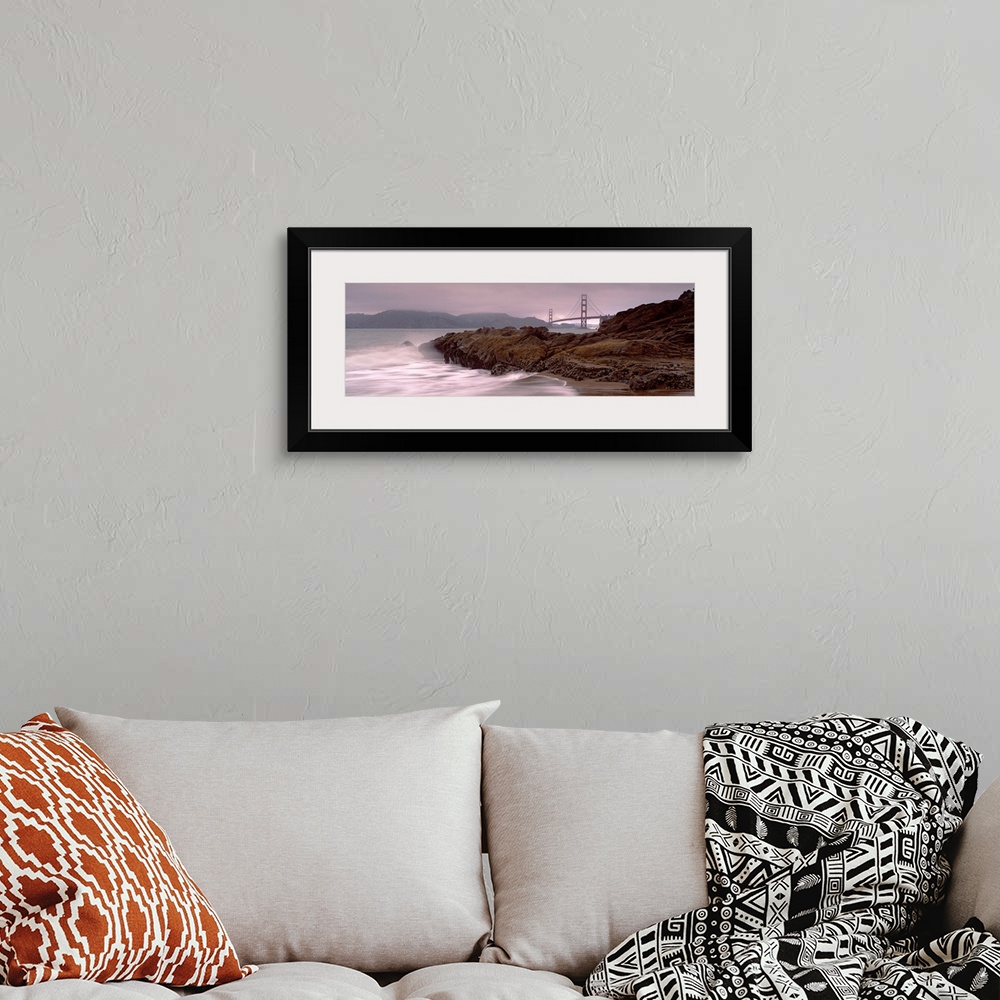 A bohemian room featuring Panoramic photograph shows waves breaking against the rocky shores of Baker Beach in San Francisc...