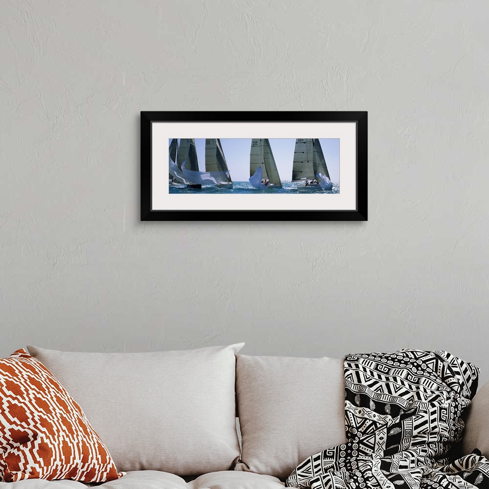 A bohemian room featuring Giant, wide angle photograph of five yachts racing on a sunny day, in the waters of Key West, Flo...