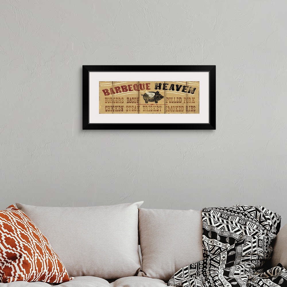 A bohemian room featuring Long horizontal image on canvas of a painting of a pig with wings with the text "Barbeque Heaven".