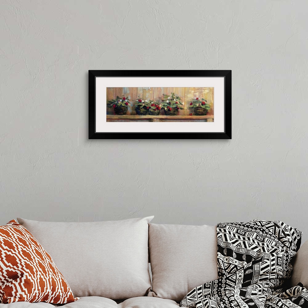 A bohemian room featuring Long canvas painting of strawberry plants in pots on a wooden shelf.
