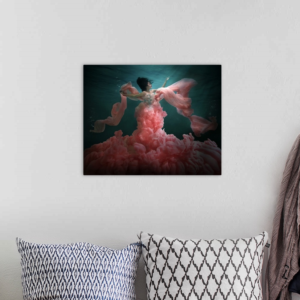 A bohemian room featuring Underwater photo of a woman wearing a billowing pink dress.