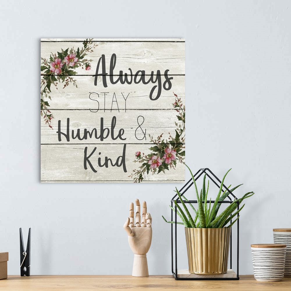 A bohemian room featuring "Always Stay Humble and Kind" with a wreath of flowers on a gray wood plank background.