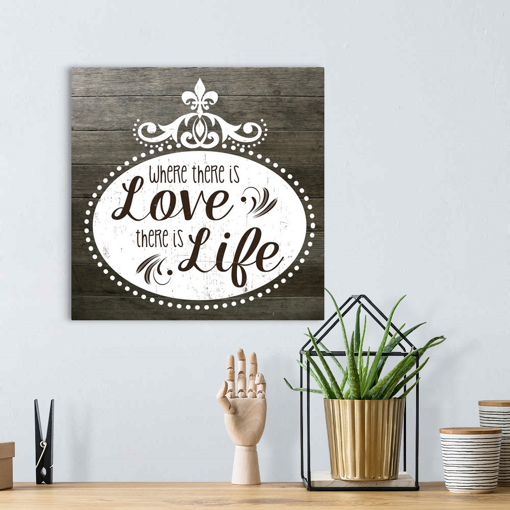 A bohemian room featuring The phrase "Where there is love there is life" on a vintage marquee shape over a faux wood texture.