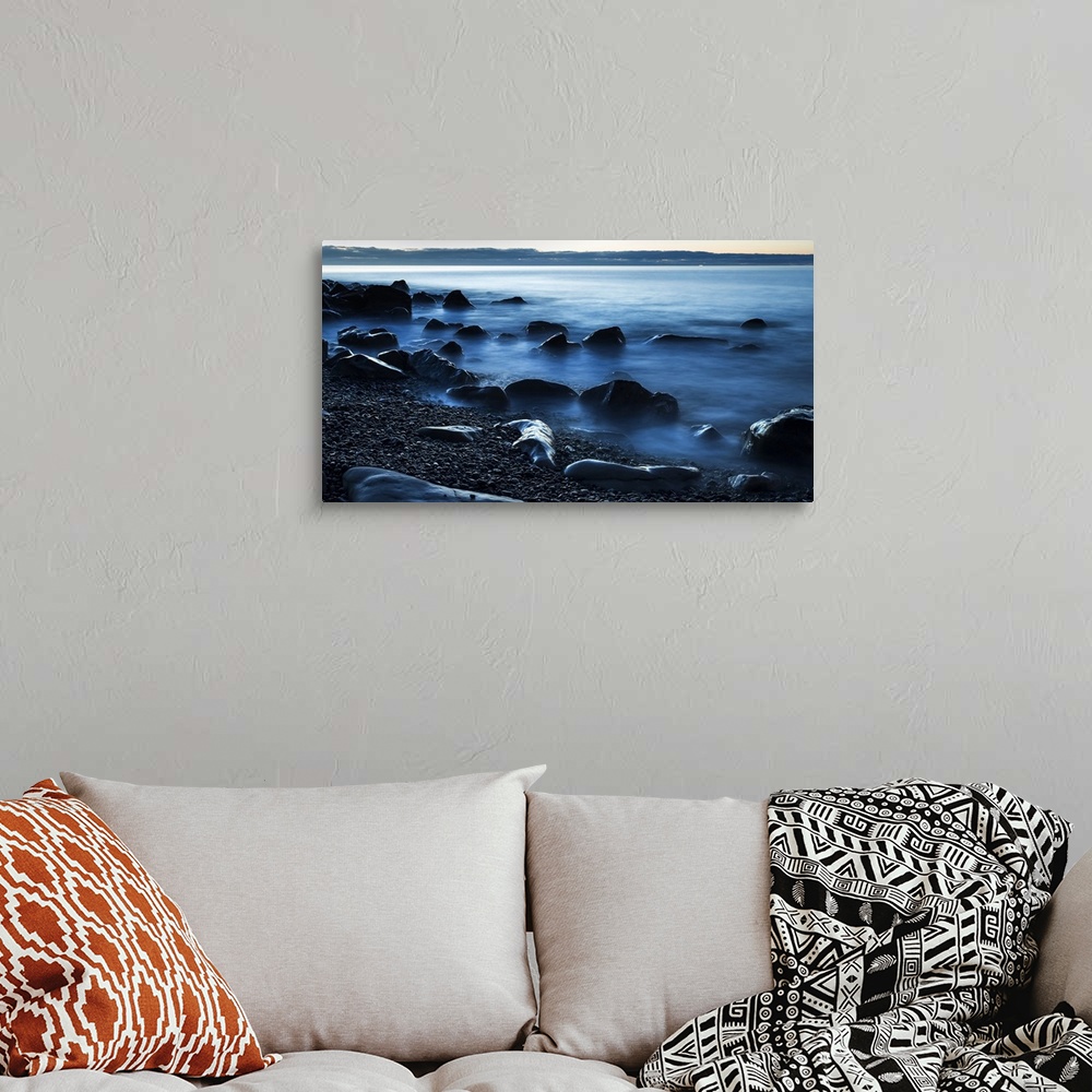 A bohemian room featuring Beautiful blue misty ocean washing in against rocks on a West Coast beach; Greymouth, New Zealand