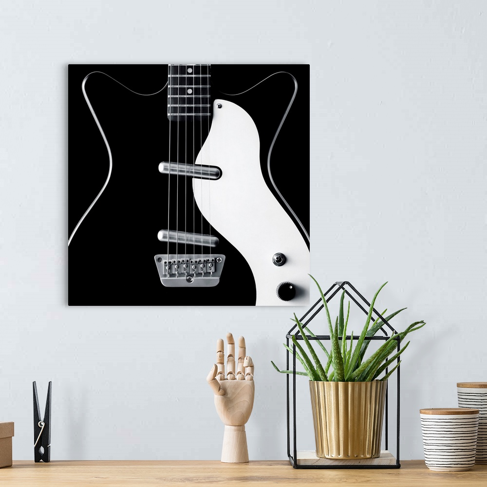 A bohemian room featuring Close-up of a black and white electric guitar.