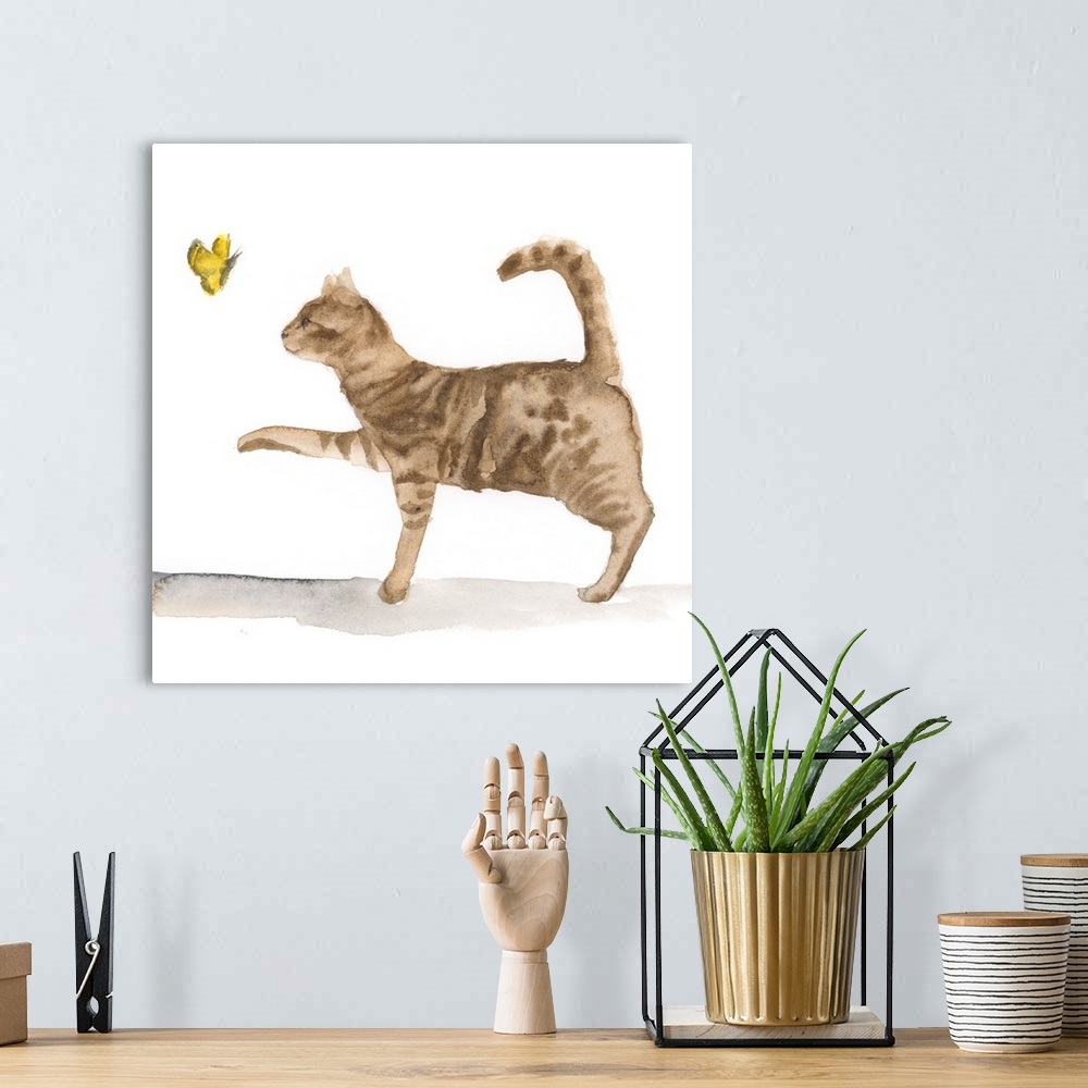 A bohemian room featuring Sweet watercolor painting of a brown tabby cat chasing a butterfly.