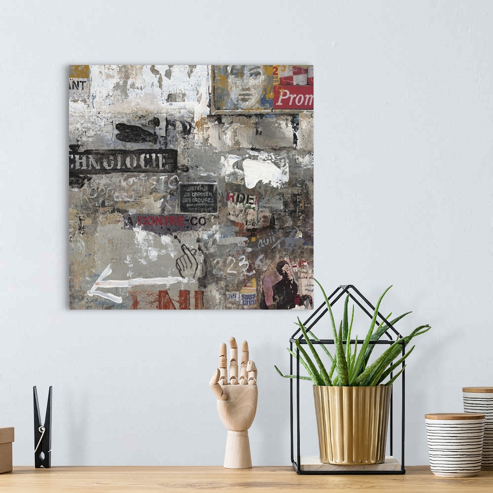A bohemian room featuring Contemporary painting of graffiti and clippings arranged in a collage in moody grey tones.