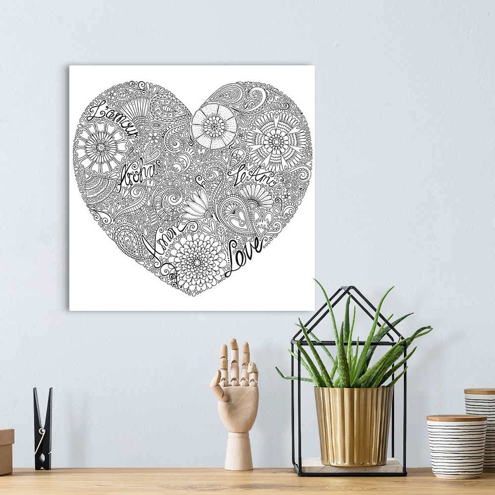 A bohemian room featuring Black and white line art made out of flowers creating a heart shape with the word "love" written ...