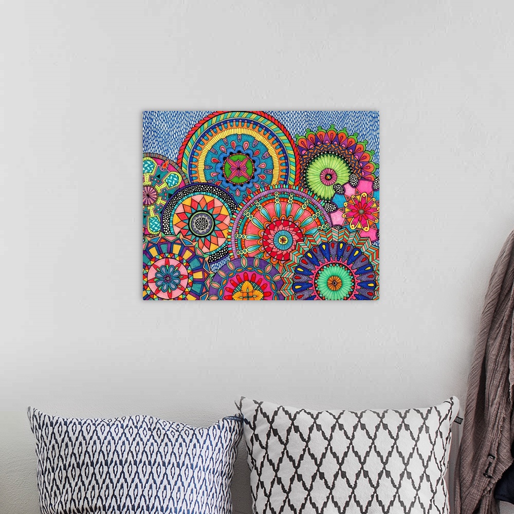 A bohemian room featuring Contemporary abstract artwork of brightly colored and patterned organic shapes.