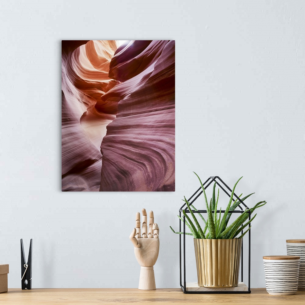 A bohemian room featuring An artistic photograph of reddish purple smooth layered rock formations.