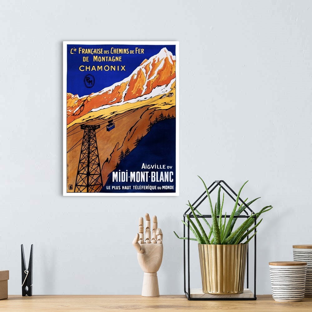 A bohemian room featuring Vintage travel advertisement artwork for Chamonix rail travel.