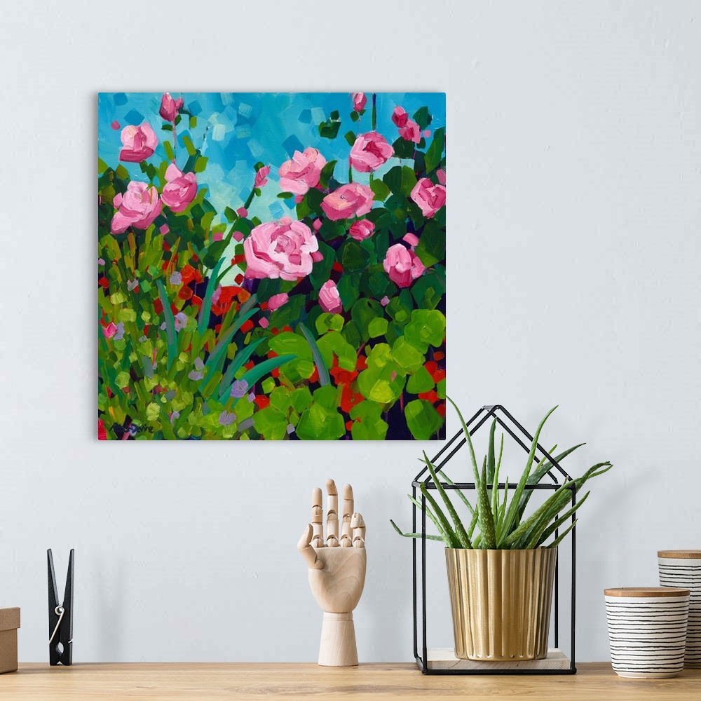 A bohemian room featuring Pink roses and red flowering geranium painting in front of a blue sky.